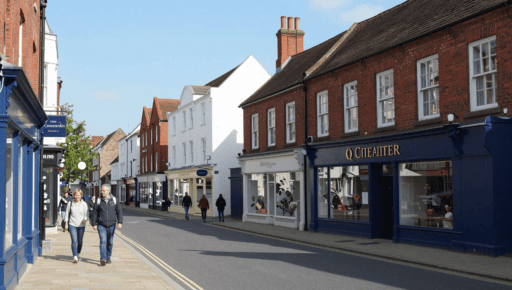 A photo of Trinity Street Coventry with pedestrians walking near shops.